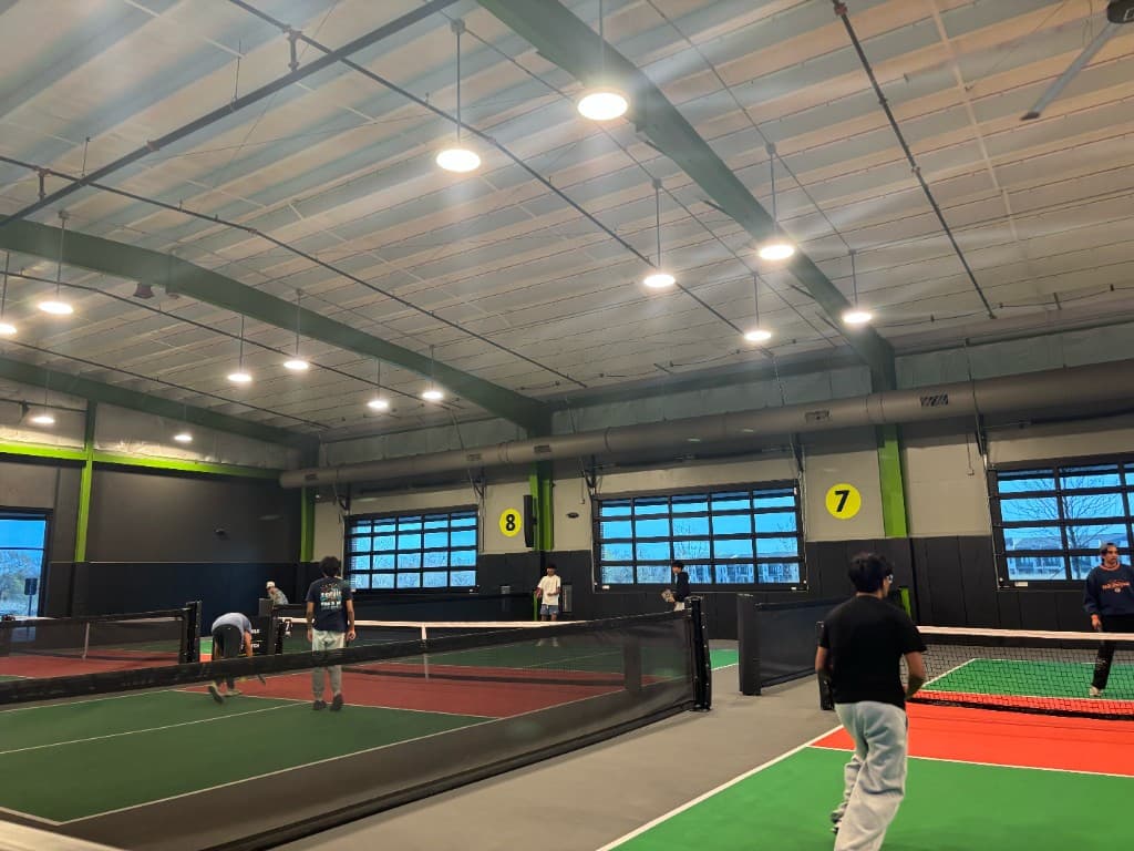 Participants playing pickleball at the Charity Pickleball Tournament at Chicken N Pickle